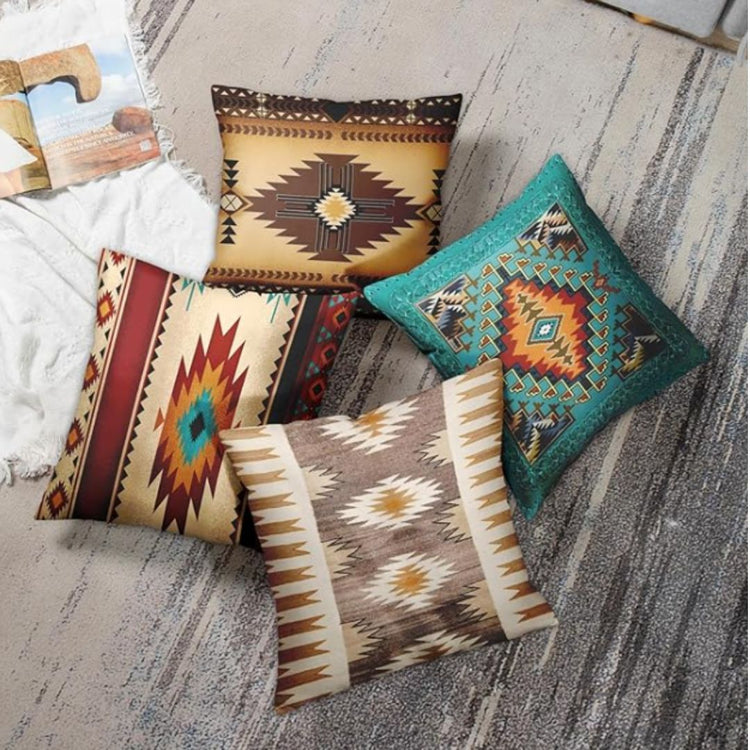 Four brown, cream and teal geometric cushion covers arranged together beside a sofa.