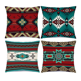 Four cushion covers with teal, red, black and cream geometric motifs.