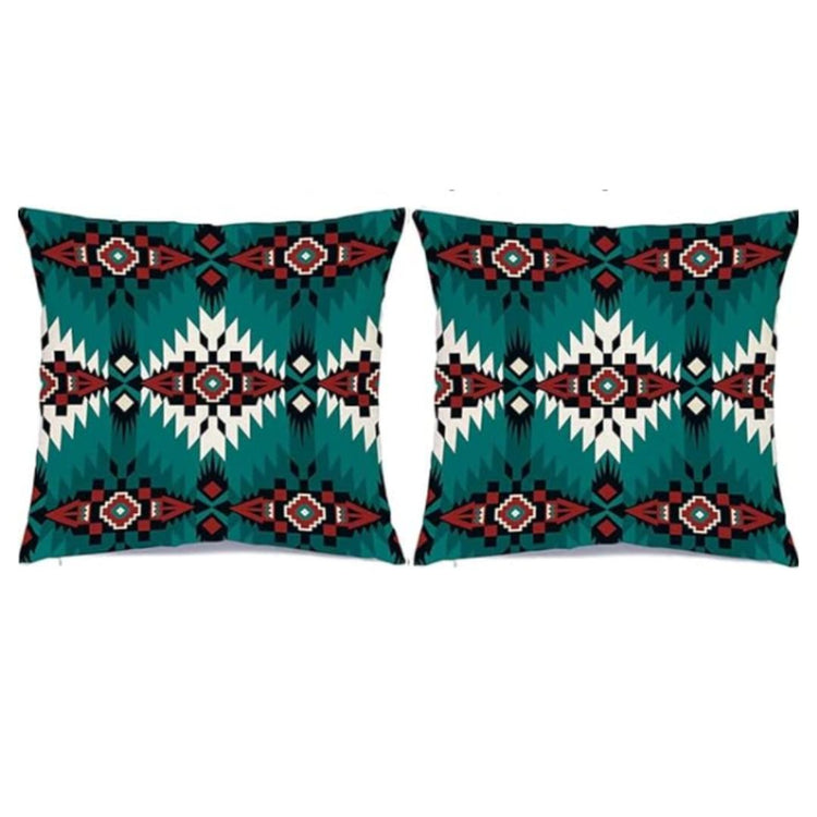 Two turquoise cushion covers with black, red and white stepped diamond patterns.