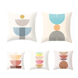 Five cream cushion covers with stacked pastel semicircle and circle designs.