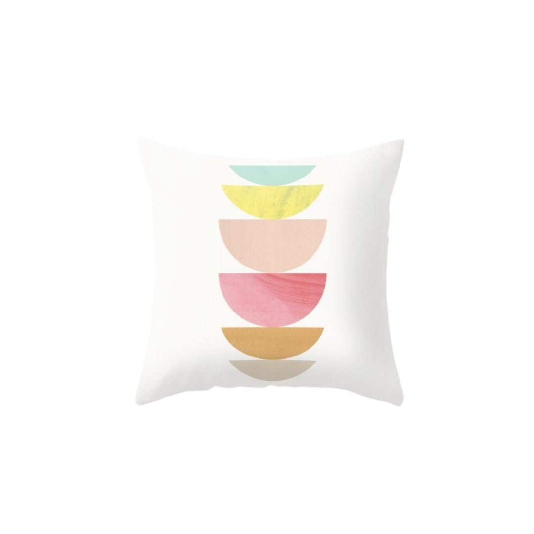 White cushion cover with stacked pastel green, yellow, pink and ochre semicircles.