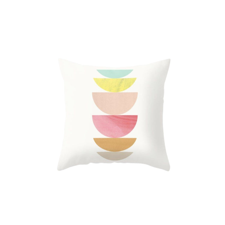 White cushion cover with stacked pastel green, yellow, pink and ochre semicircles.