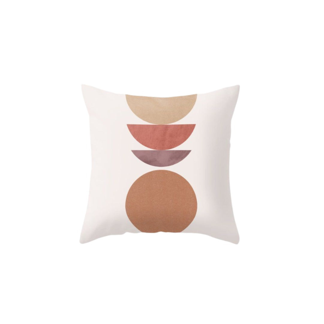 Pale pink cushion cover with stacked rust semicircles above a large brown circle.