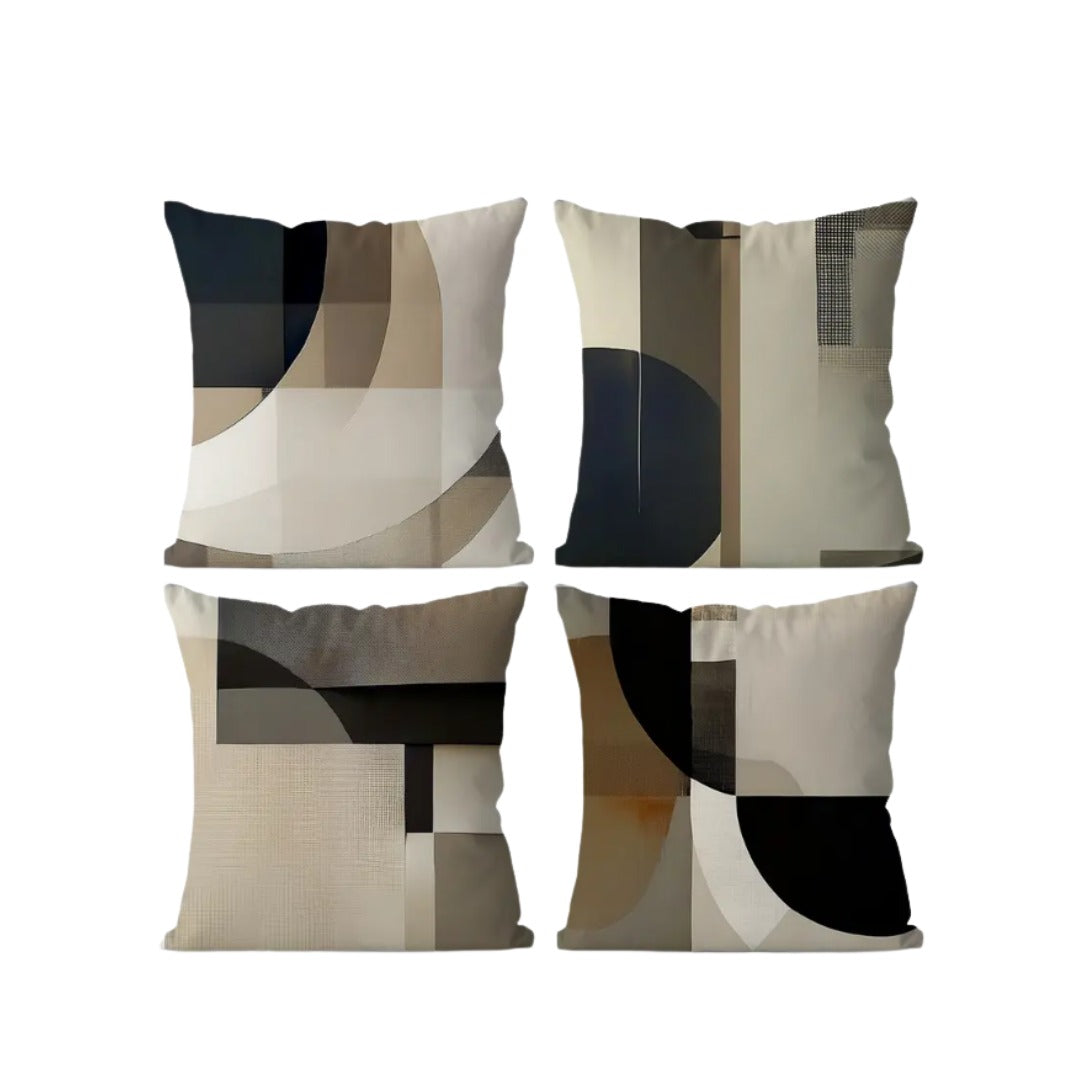 Four cushion covers with curved and rectangular black, cream and grey panels.
