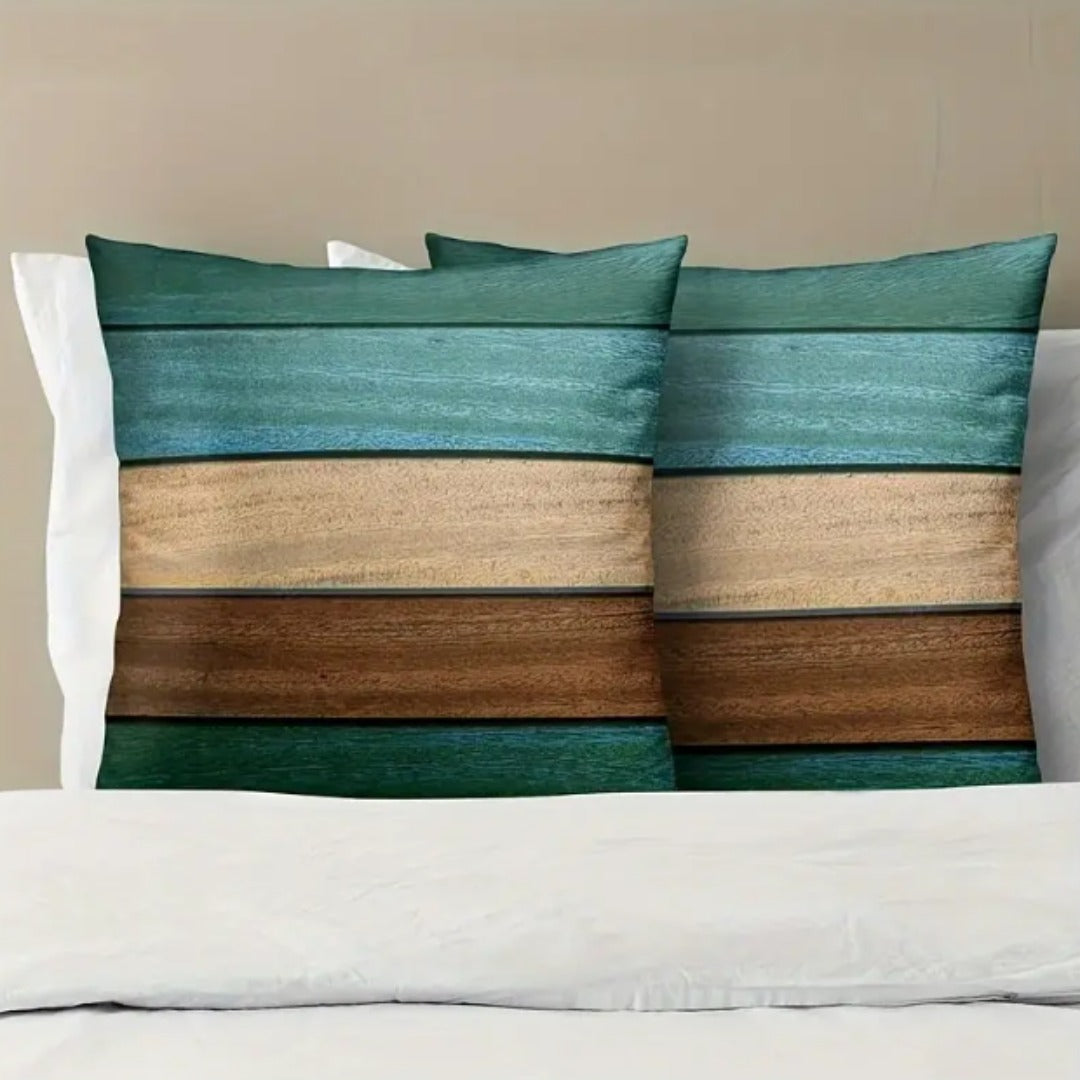 Two teal, cream and brown horizontally striped cushion covers on a white sofa.