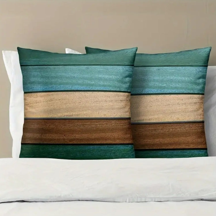 Two teal, cream and brown horizontally striped cushion covers on a white sofa.