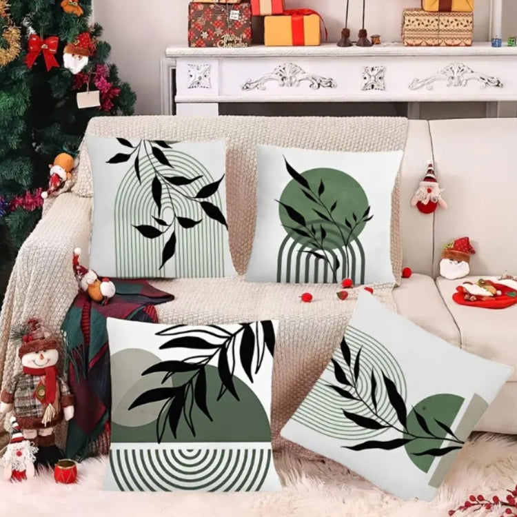 Green and black botanical cushion covers displayed beside festive decorations.