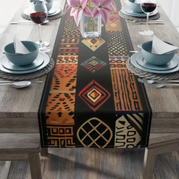 Dark table runner with orange and gold geometric motifs and decorative patterned bands.