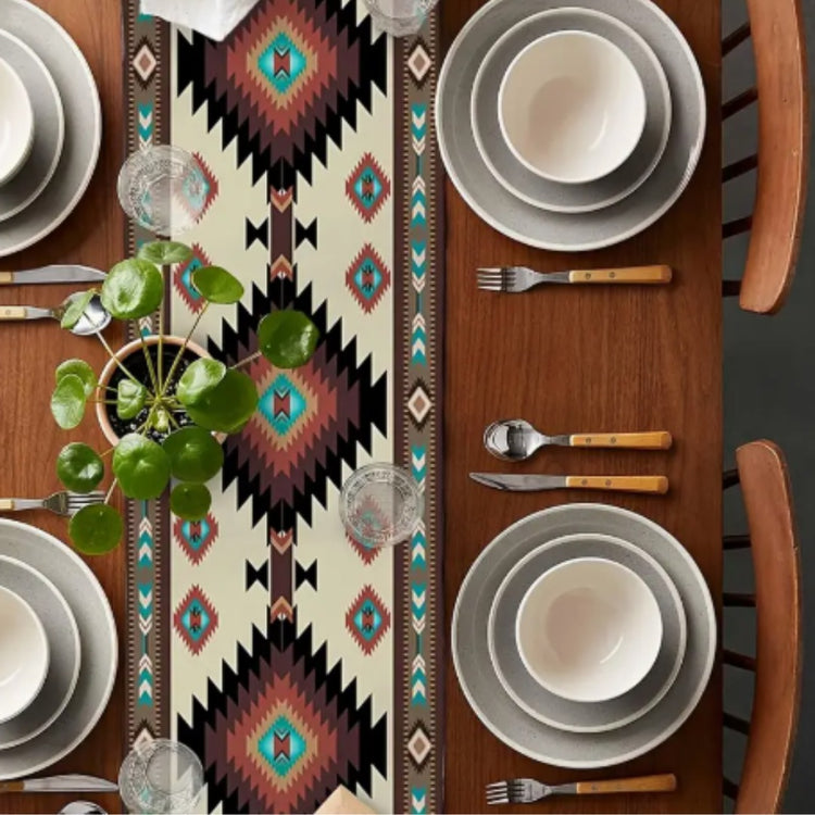 Overhead view of a cream, black and turquoise diamond-pattern table runner.
