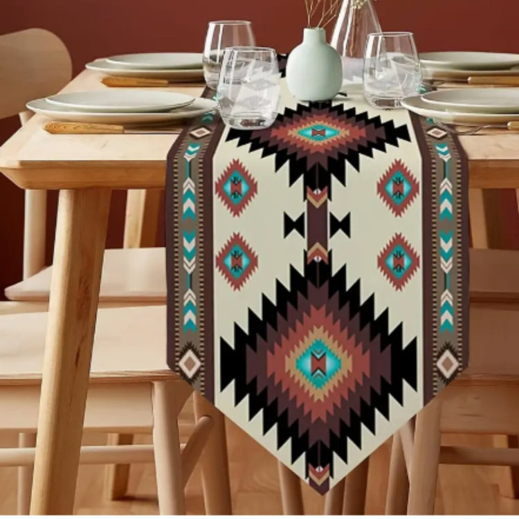 Cream table runner with large black, turquoise and rust geometric diamonds.