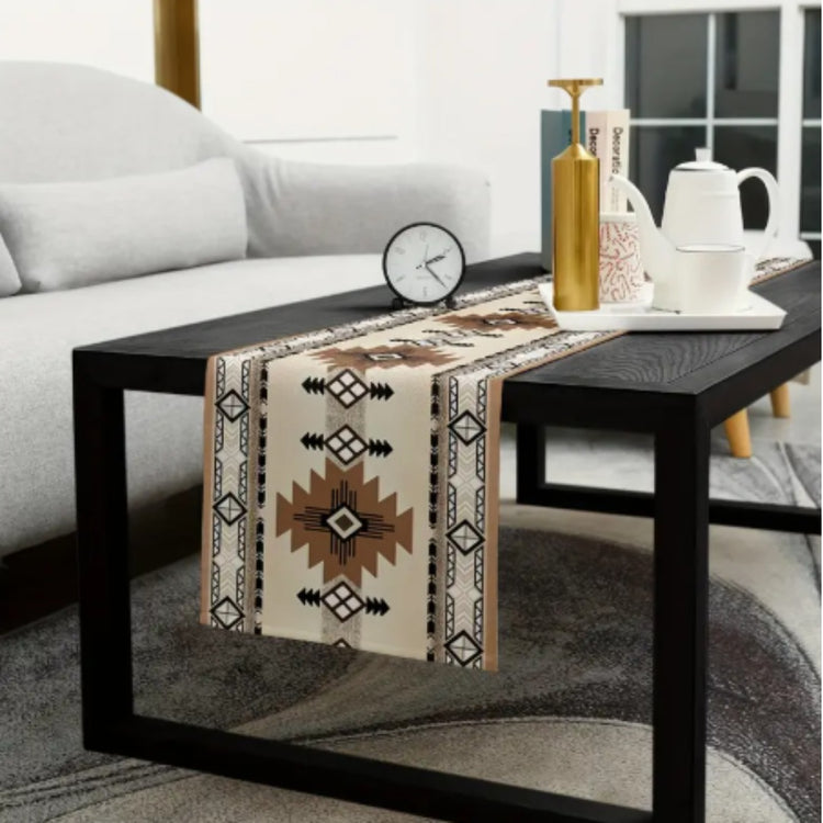 Brown and cream geometric table runner draped over a black coffee table.