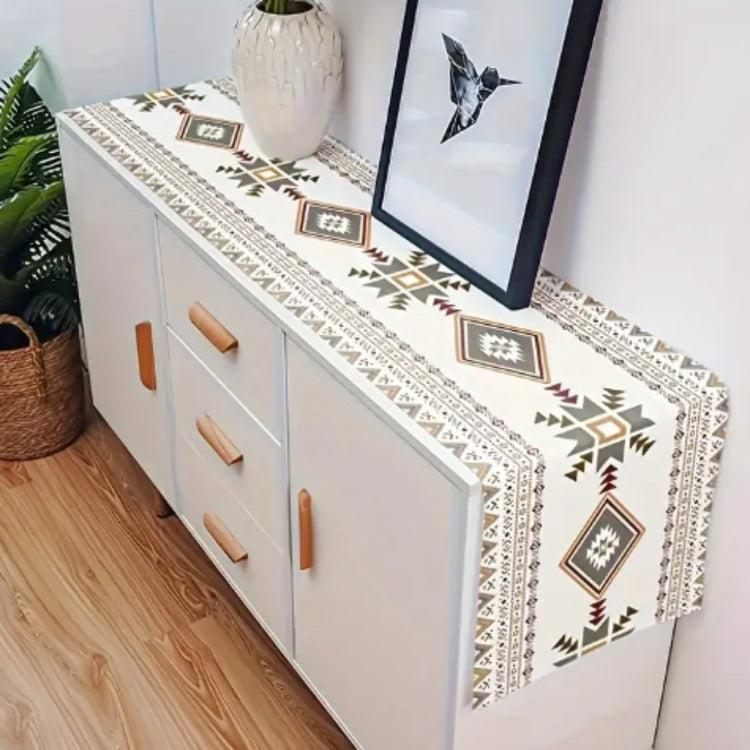 Cream geometric table runner displayed along a white sideboard.