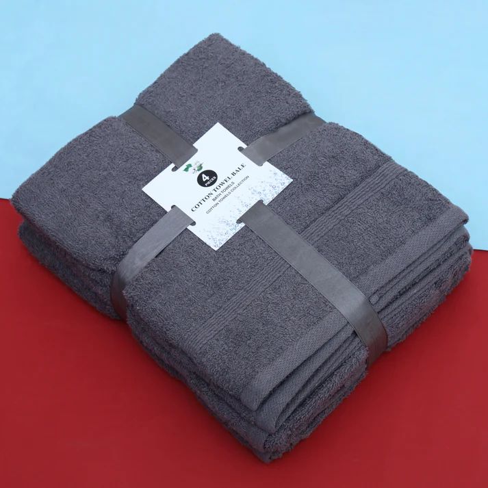 Folded charcoal grey cotton towel set tied with a ribbon.