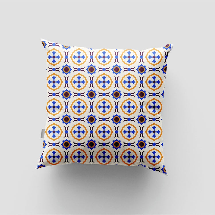 White cushion cover with blue and yellow circular tile motifs.