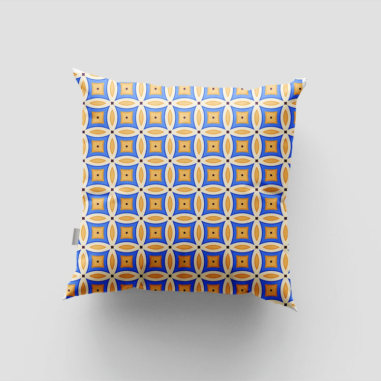 Blue cushion cover with a white and yellow grid of rounded square shapes.