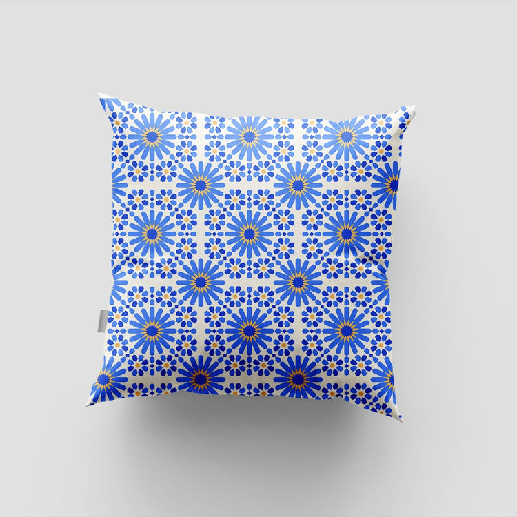 Cushion cover with a dense repeating blue and white floral tile pattern.
