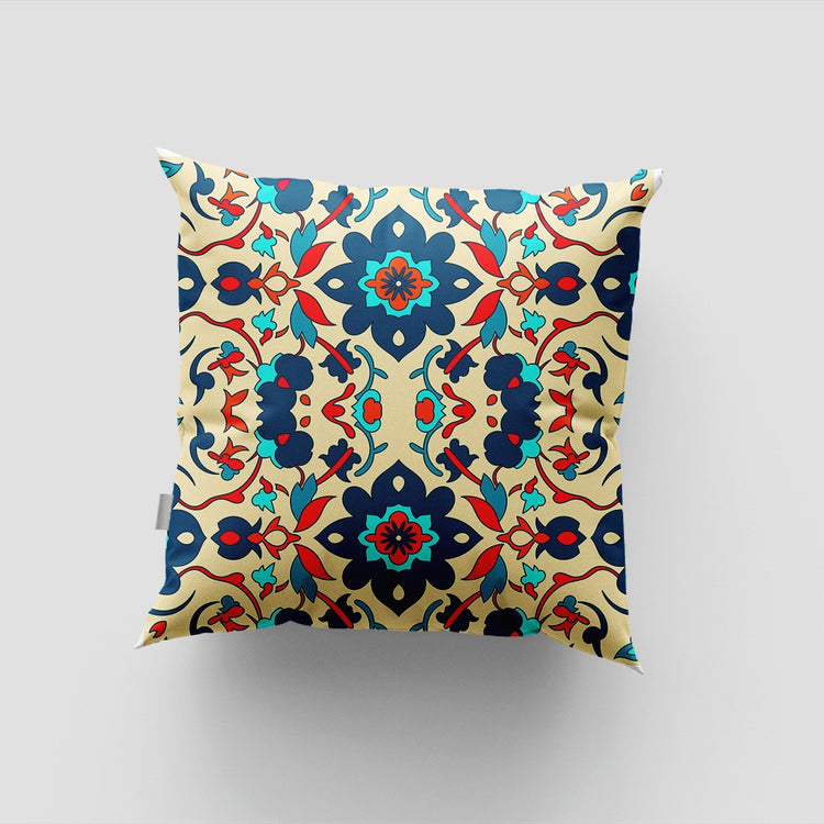 Cream cushion cover with an ornate navy, teal and rust floral pattern.