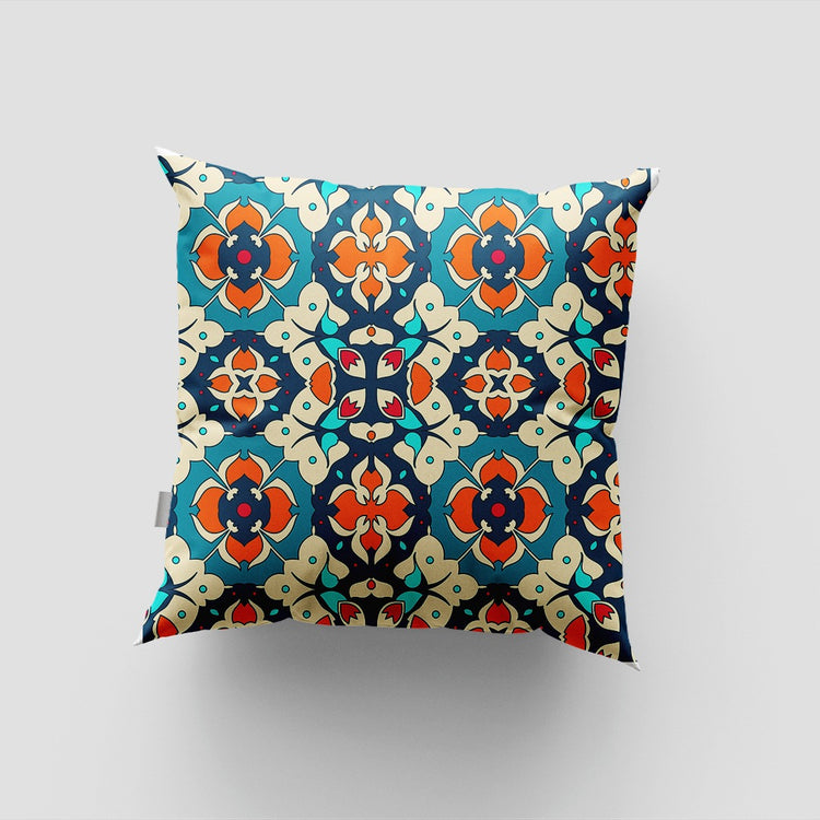 Teal cushion cover with repeating orange and cream ornate floral medallions.