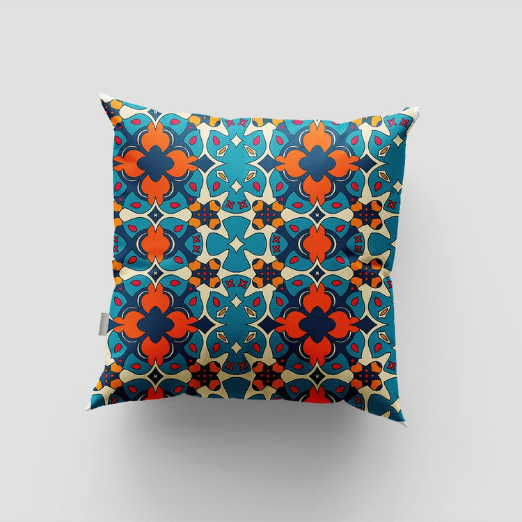 Cushion cover with a dense teal, blue, orange and cream geometric tile pattern.