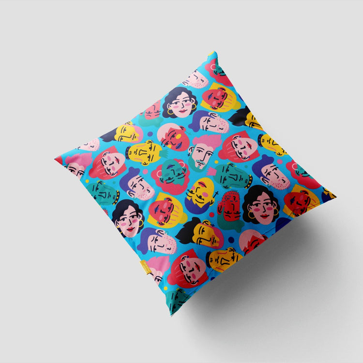 Turquoise cushion cover with colourful pop-art faces and circular motifs.