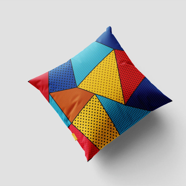 Cushion cover with bright yellow, red, blue and orange triangular panels and dotted details.