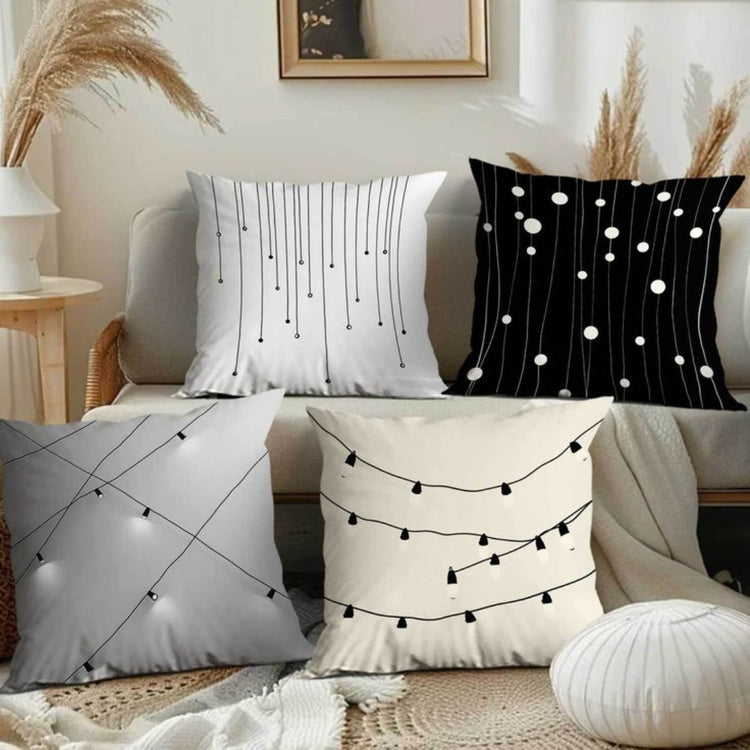 Four neutral cushion covers with fine hanging lines and small dot patterns.
