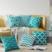 Teal and white geometric cushion covers arranged on a mustard sofa and rug.