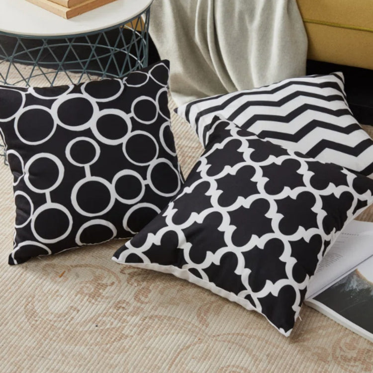 Close view of black and white circle, lattice and zigzag cushion cover patterns.