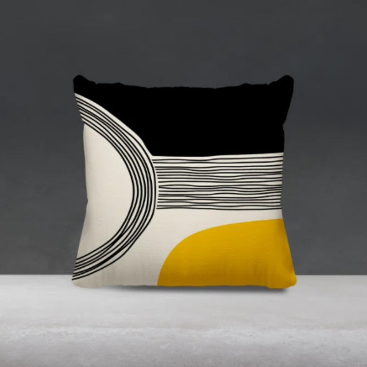 Black and cream cushion cover with fine curved lines and a yellow lower corner.