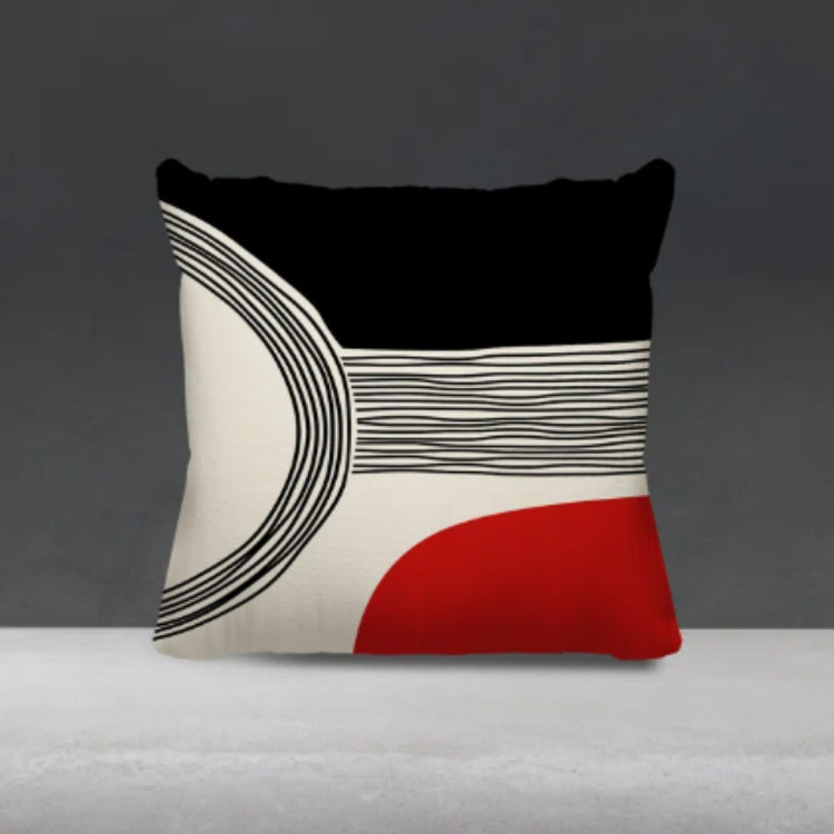 Black and cream cushion cover with fine curved lines and a red lower corner.