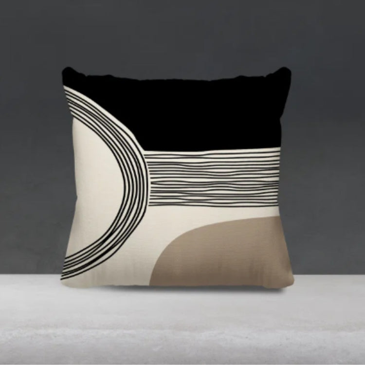 Black and cream cushion cover with fine curved lines and a taupe lower corner.