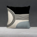 Black and cream cushion cover with fine curved lines and a pale blue lower corner.