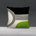 Black and cream cushion cover with fine curved lines and a green lower corner.