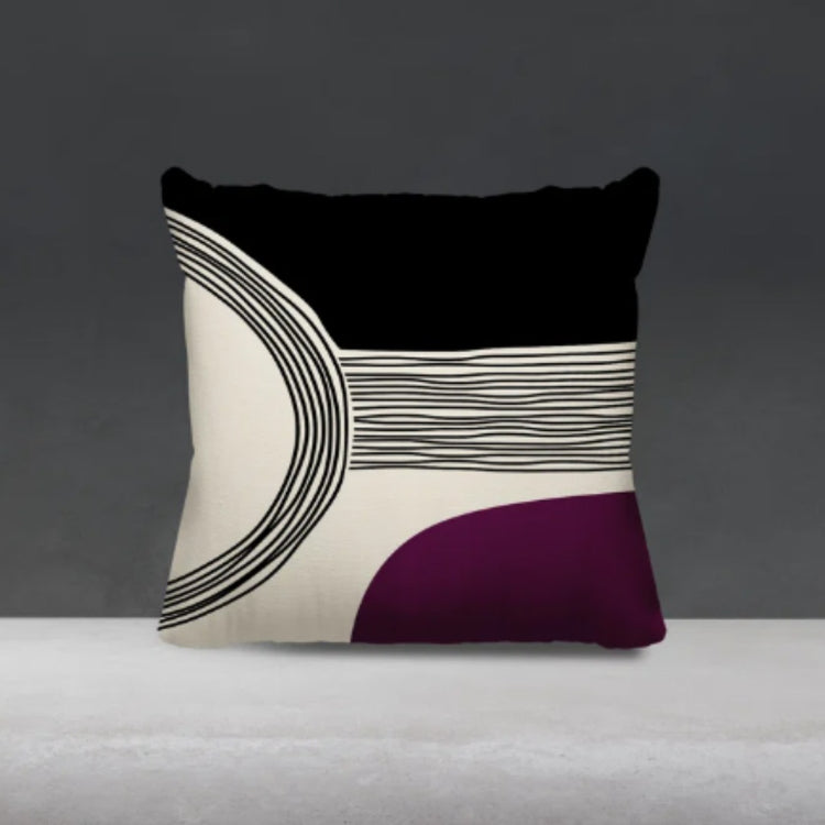 Black and cream cushion cover with fine curved lines and a purple lower corner.