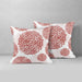 Two white cushion covers with muted red circular floral patterns.