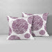 Two white cushion covers with purple circular floral patterns.