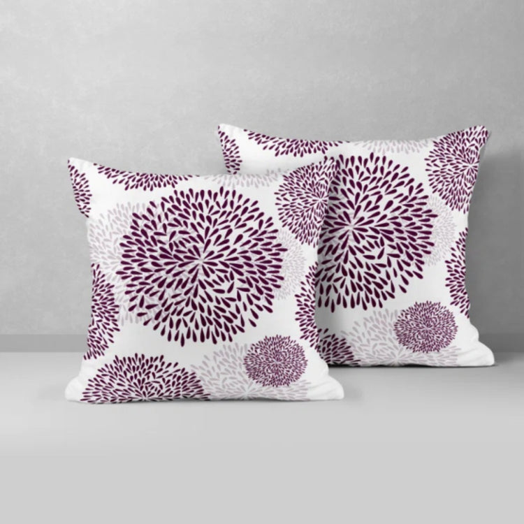 Two white cushion covers with purple circular floral patterns.