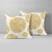 Two white cushion covers with mustard circular floral patterns.