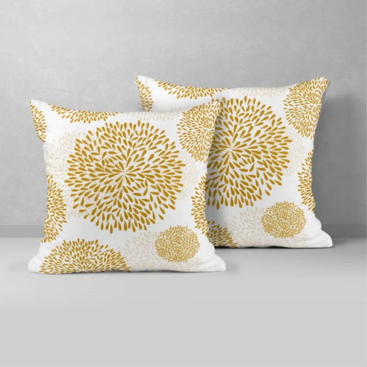 Two white cushion covers with mustard circular floral patterns.