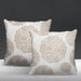 Two white cushion covers with beige circular floral patterns.