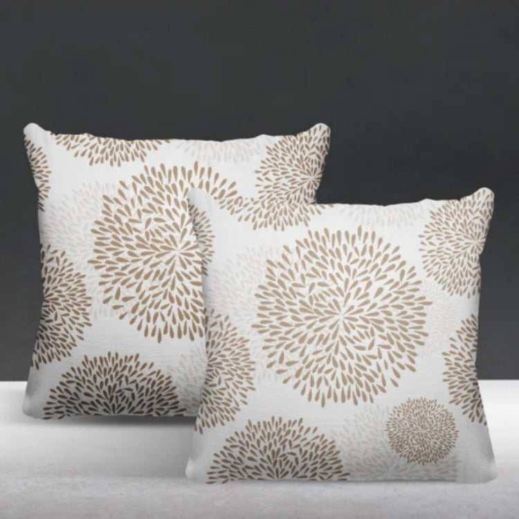 Two white cushion covers with beige circular floral patterns.