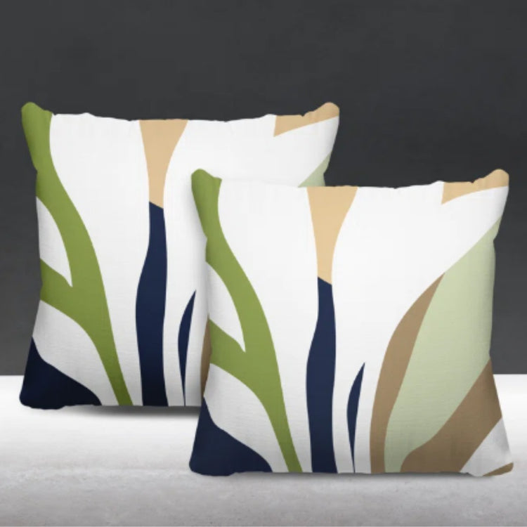 Two cream cushion covers with olive green, navy and beige abstract leaf-like shapes.