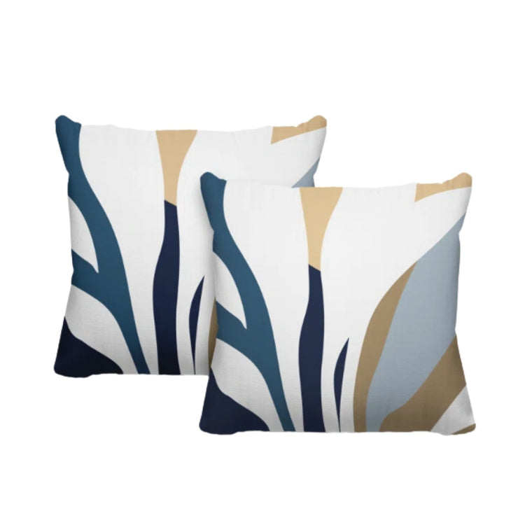 Two cream cushion covers with navy, blue-grey and beige abstract leaf-like shapes.