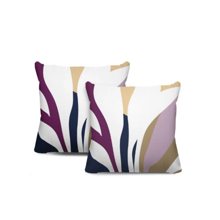 Two cream cushion covers with purple, navy and beige abstract leaf-like shapes.
