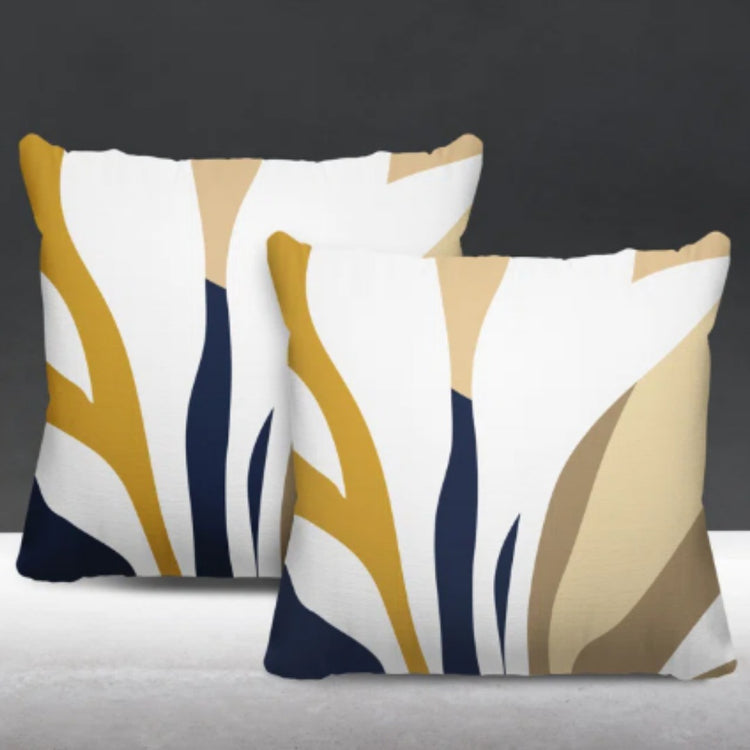 Two cream cushion covers with mustard, navy and beige abstract leaf-like shapes.