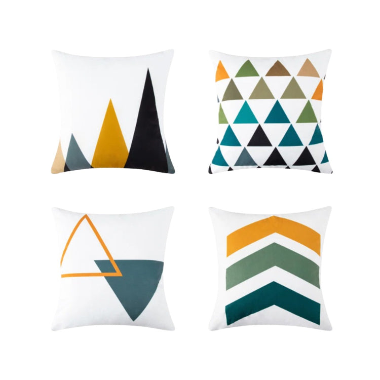 Four white cushion covers with mustard, teal, grey and black triangle and chevron designs.