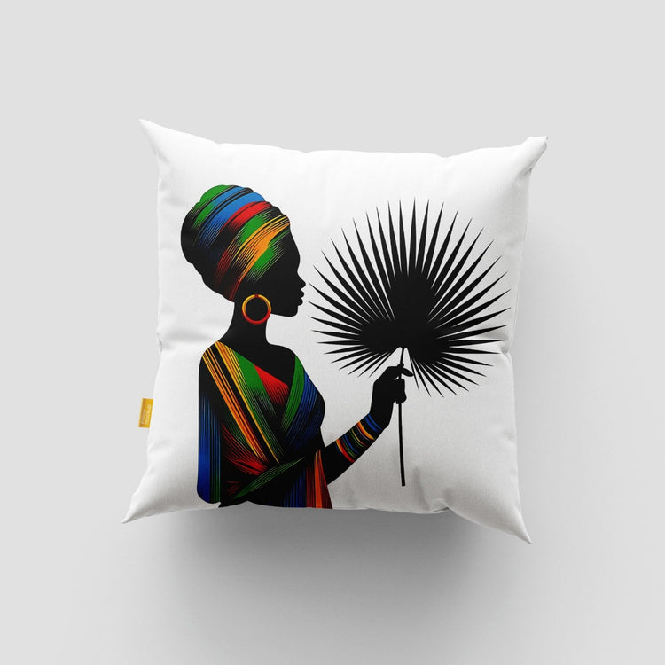 White cushion cover with a woman in a colourful headwrap holding a black fan-shaped leaf.