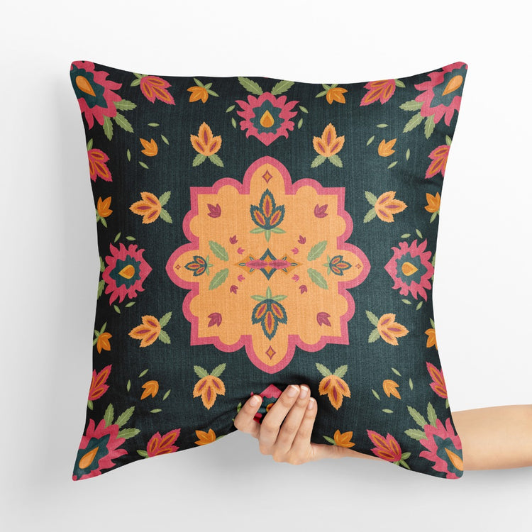 Dark green cushion cover with a large yellow and orange floral centre and small flowers.