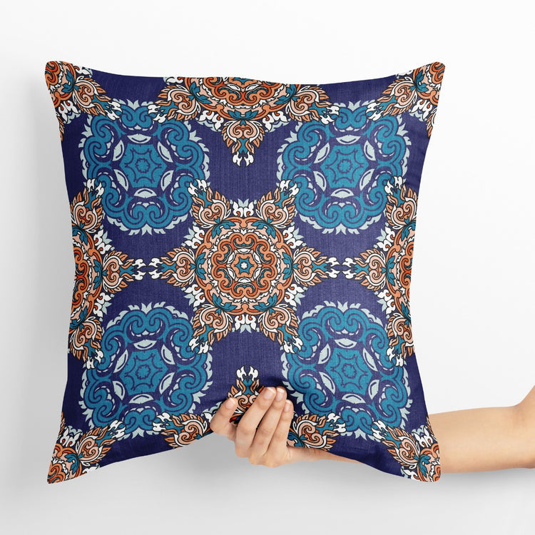 Navy cushion cover with turquoise circular ornaments and a small central floral medallion.