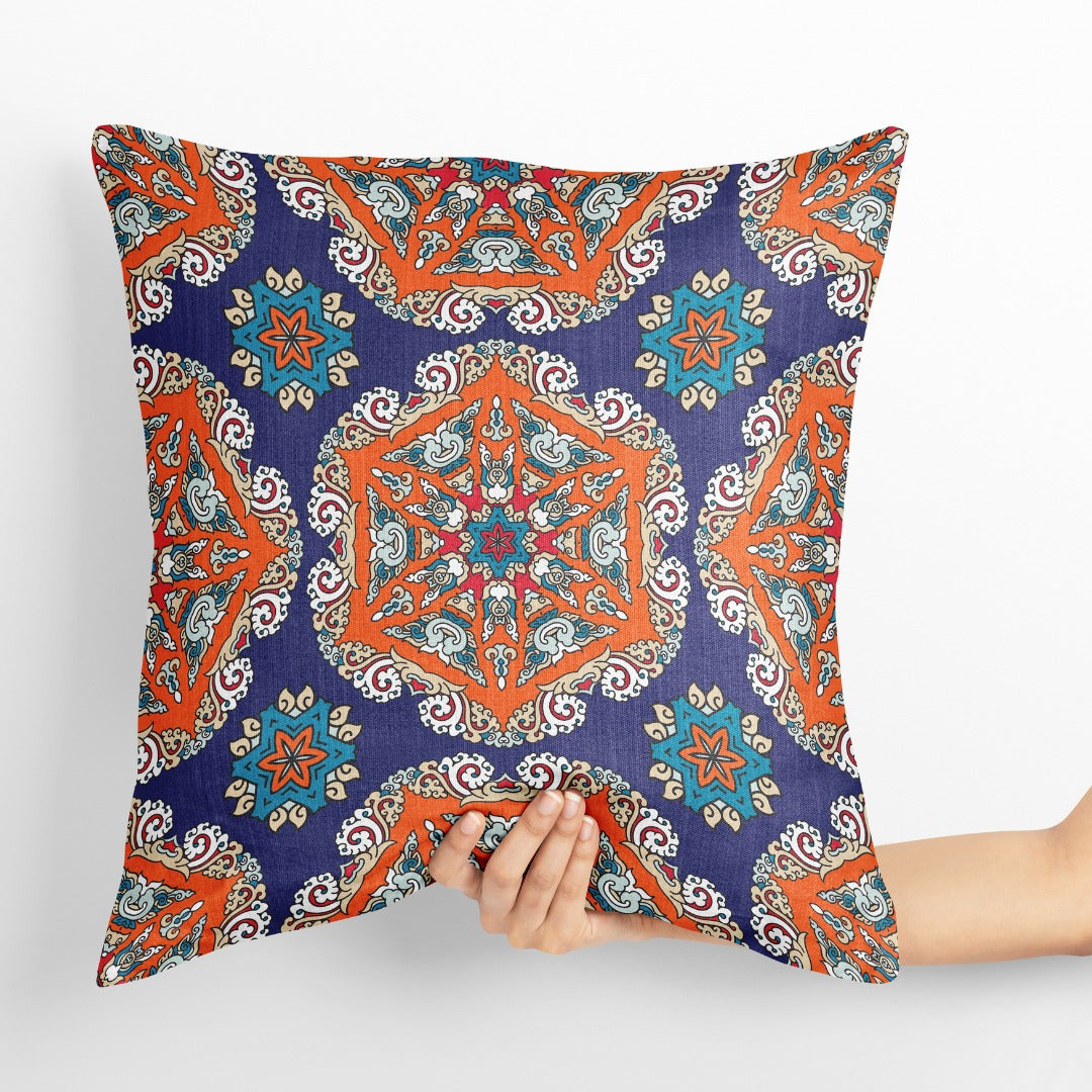 Blue cushion cover with ornate orange and turquoise floral medallions.
